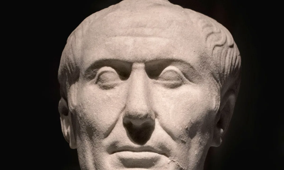 Marble head of a thin, lined, balding man with a long neck and a slight frown.