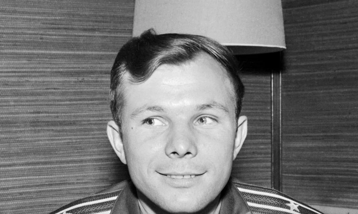 Portrait of a smiling young man in a dark military cap and uniform.