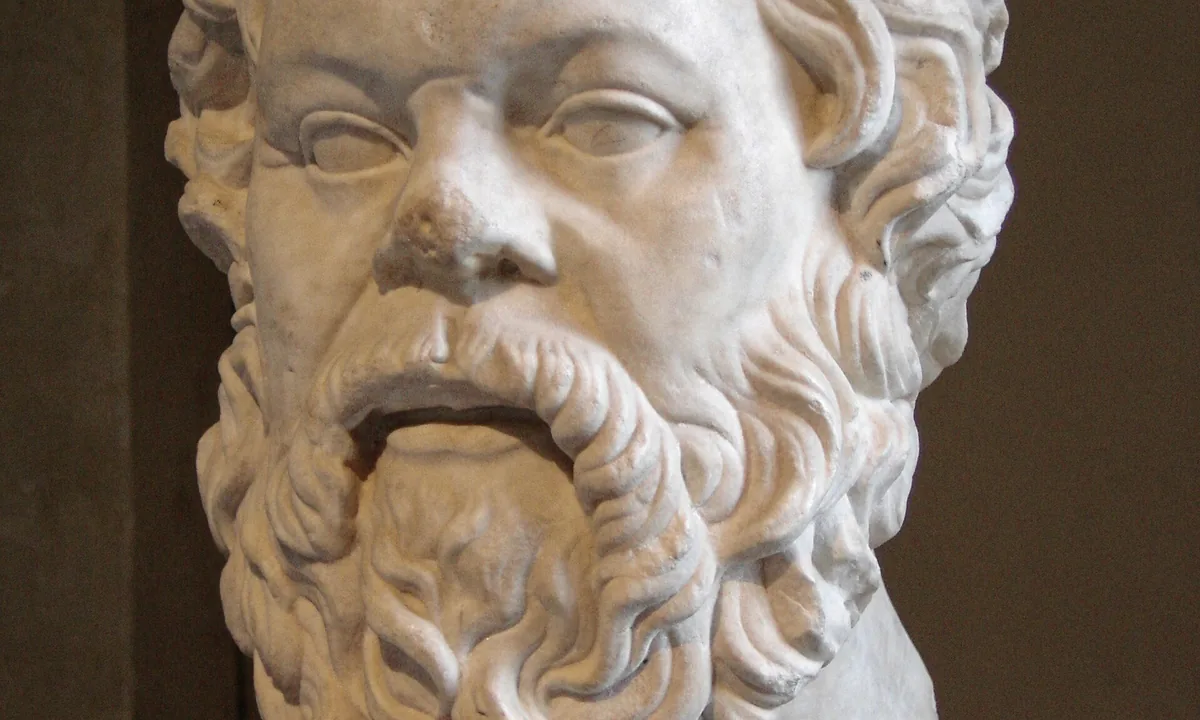 Marble head of a balding, bearded man with a broad snub nose.