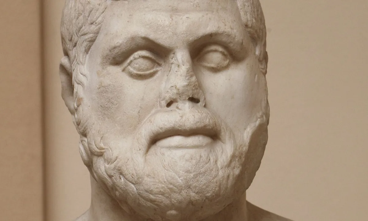 Marble bust of a heavy-set man with short curly hair, a broad face and a full beard.