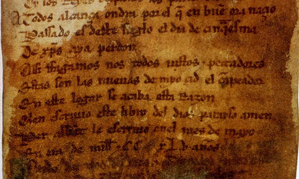 A brown, stained parchment page of dark medieval Gothic handwriting in short lines of verse.