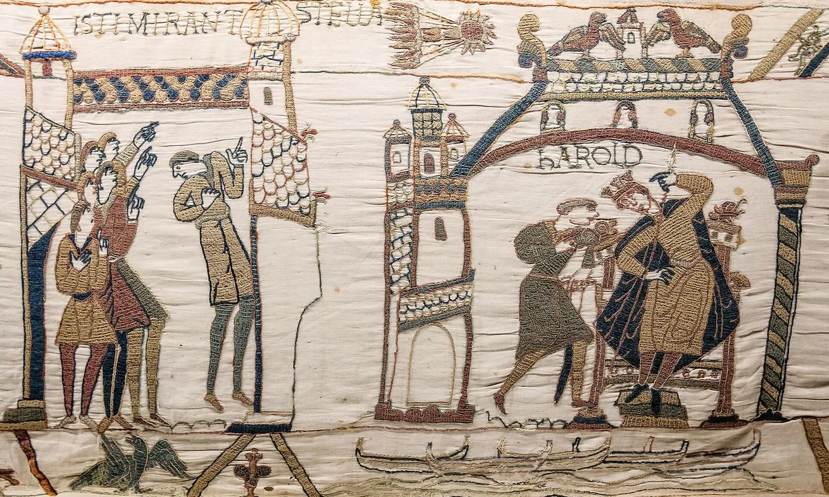 Embroidered scene of a crowned king on a throne and a group of men looking up and pointing at a star with streaming tail.
