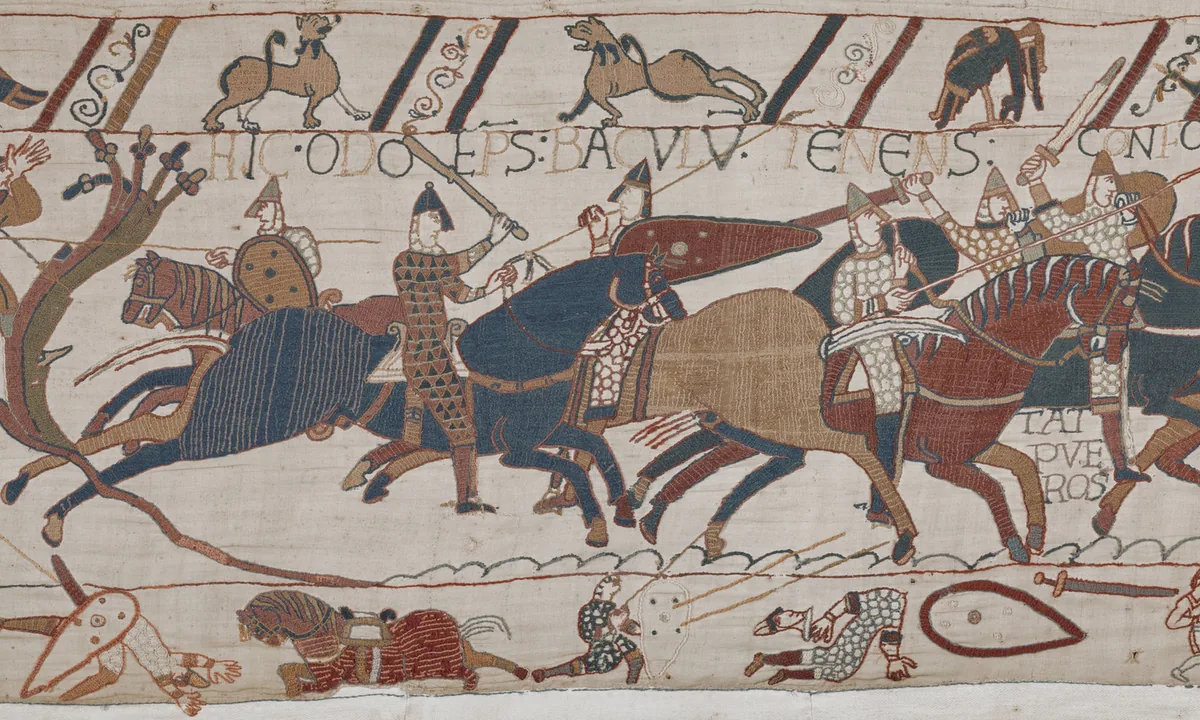Embroidered scene of a mounted figure in armour holding a club, riding among galloping knights.