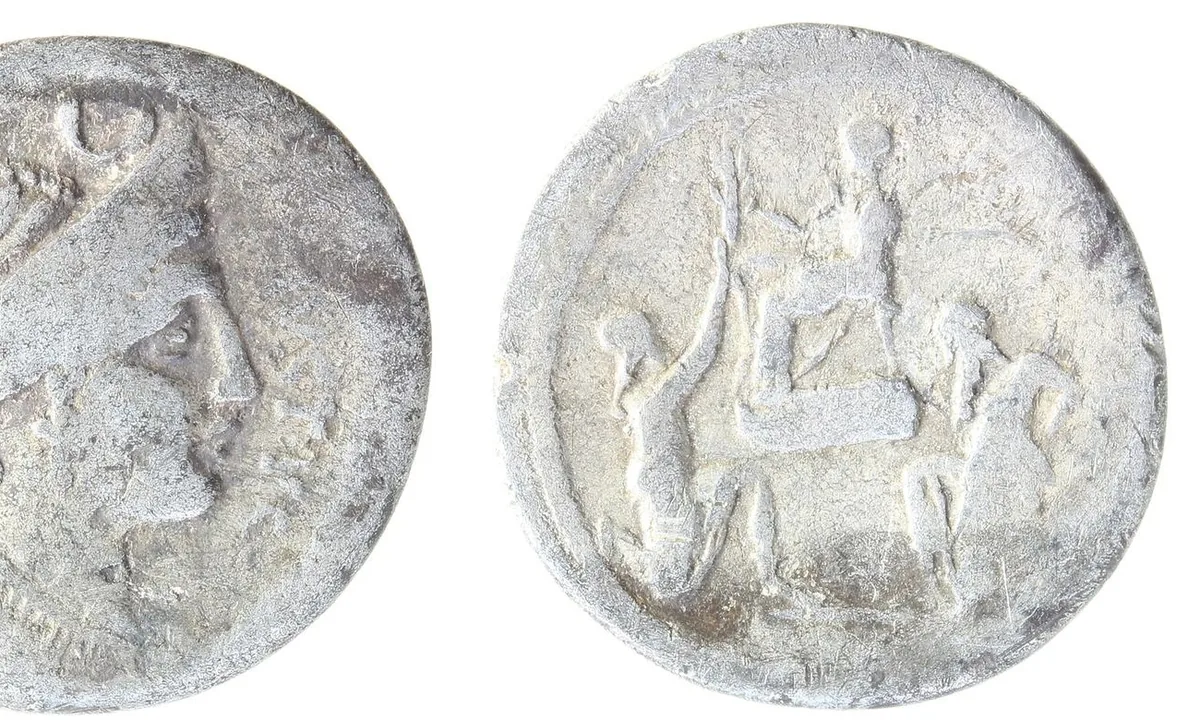Silver Roman coin showing a seated figure with two kneeling figures before him.