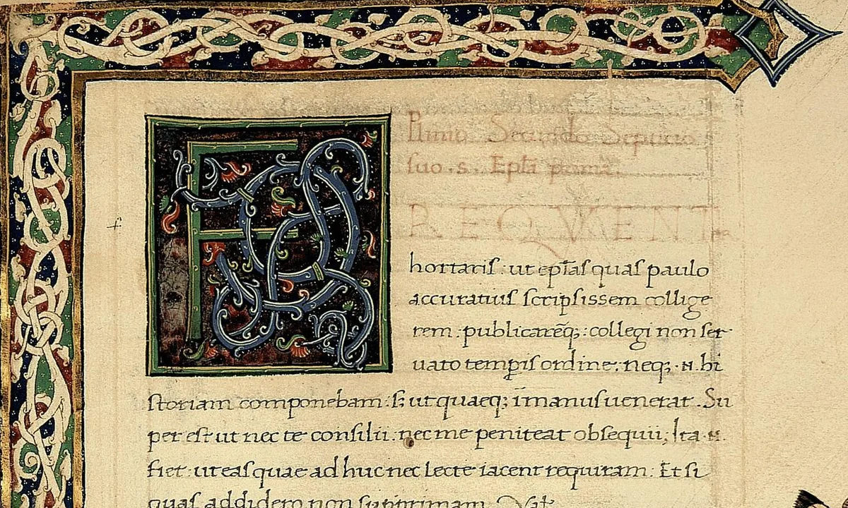 Page of a handwritten Latin manuscript with a large decorated initial F in blue, green and gold, a border of interlaced vines and lines of brown script.