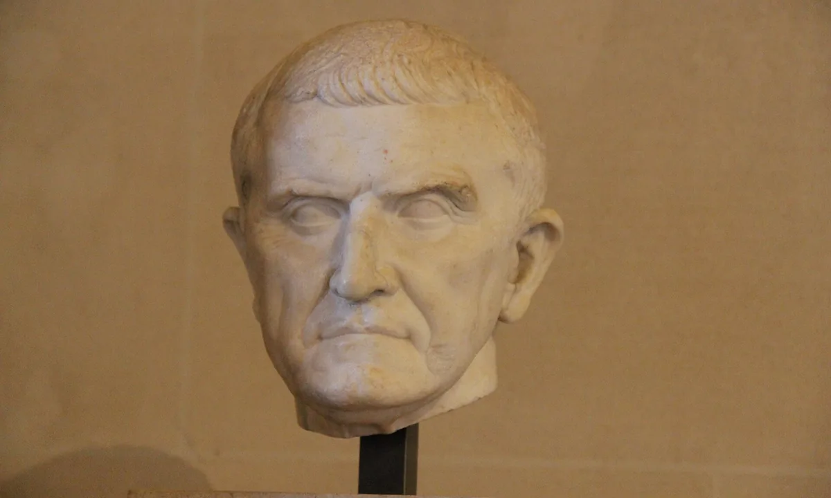 Marble head of a middle-aged man with short hair and a heavy brow, seen from the front.